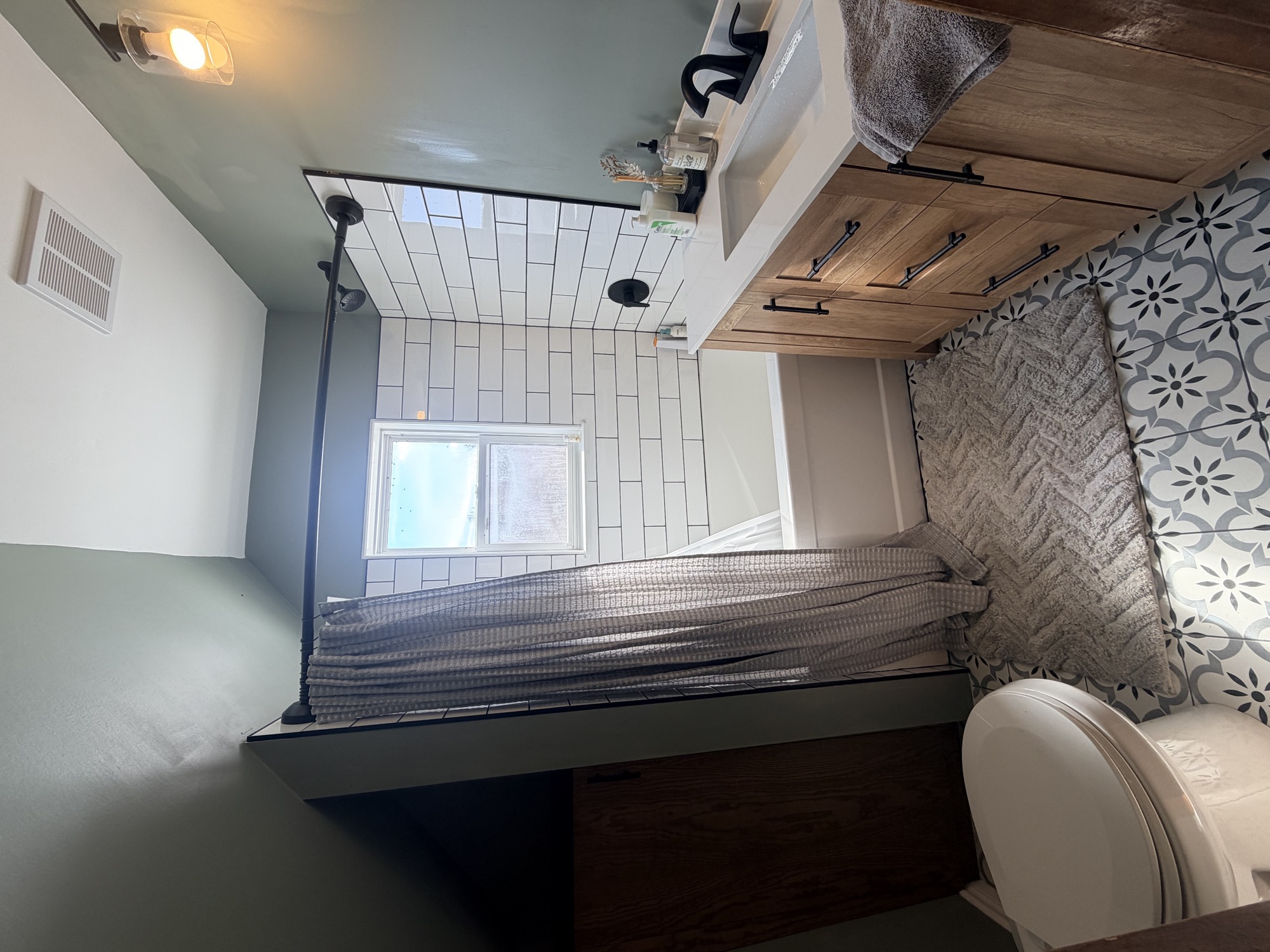 Completed bathroom renovation with updated vanity and tile.
