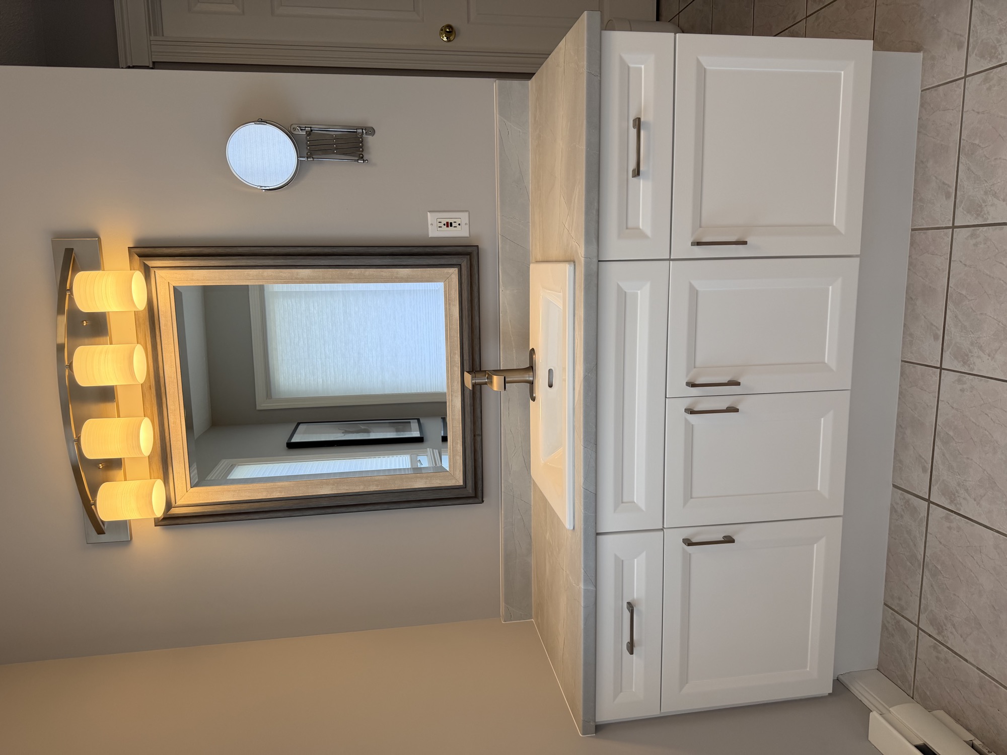 Refinished bathroom cabinet with fresh paint, updated countertop, and new sink.