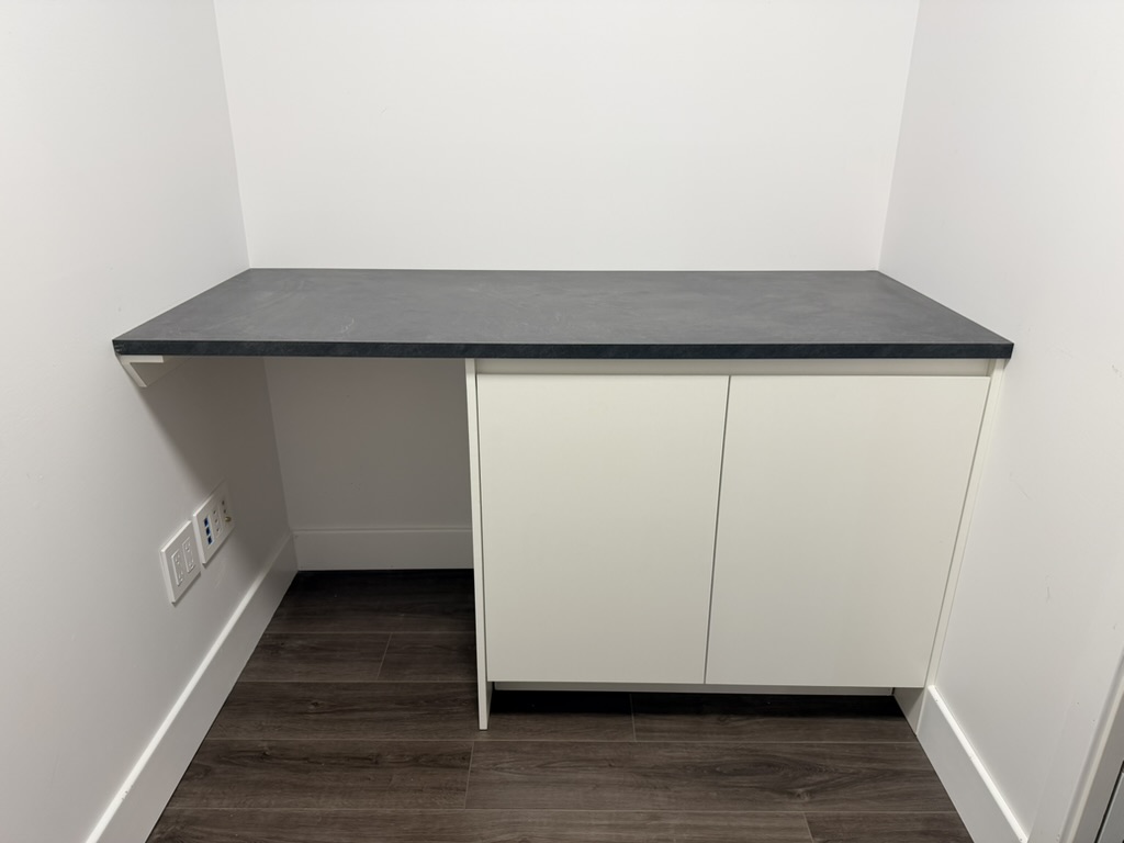 Built-in storage cabinet with desk-height work surface.