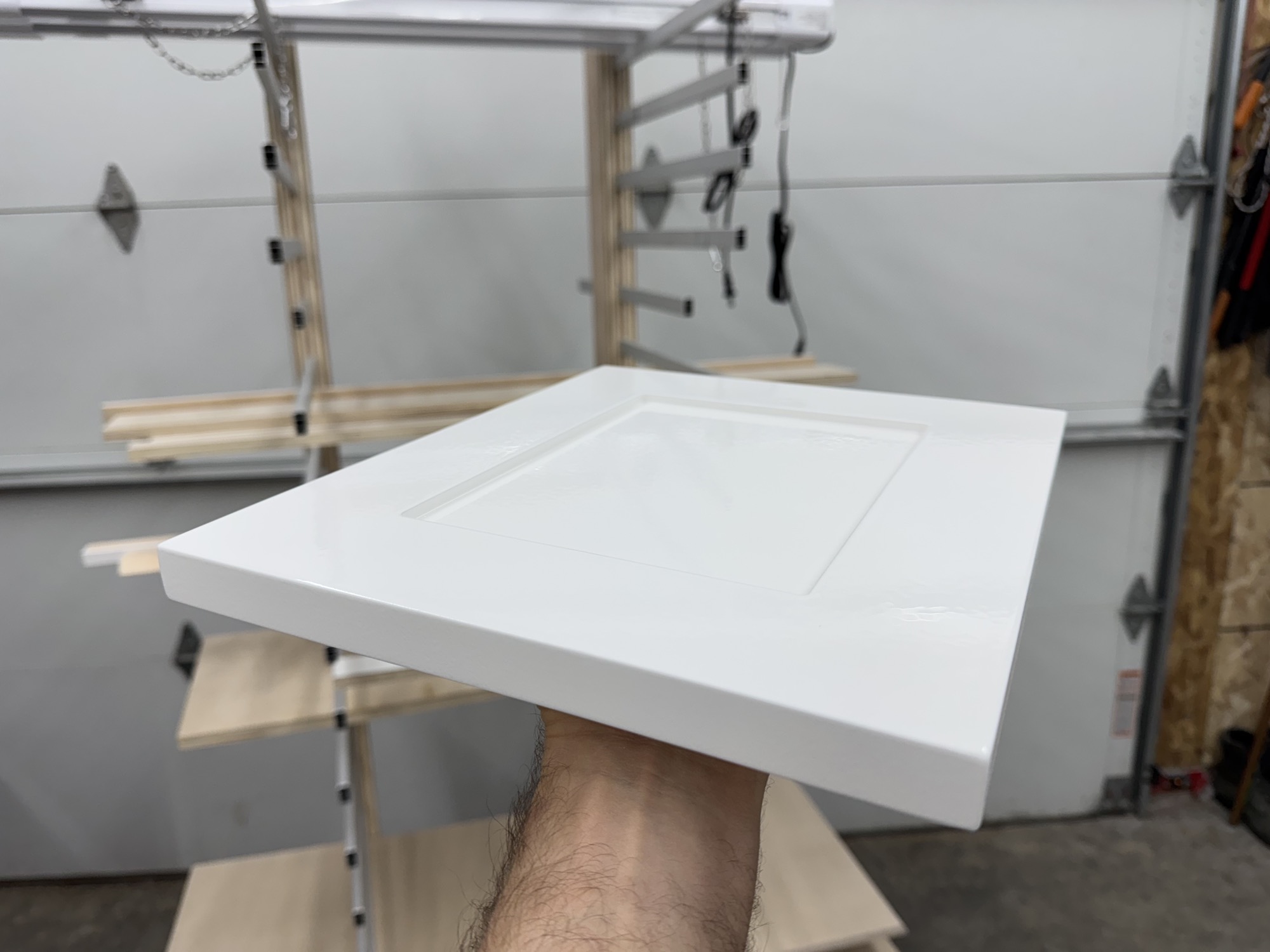 Freshly finished cabinet door drying in the shop.