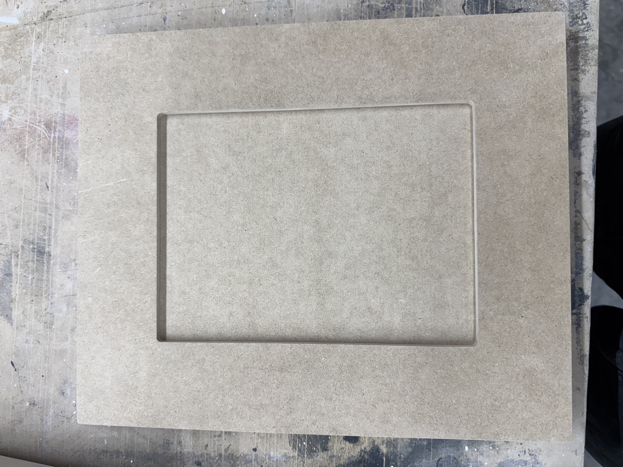 Flat cabinet door panel prepared for refinishing.