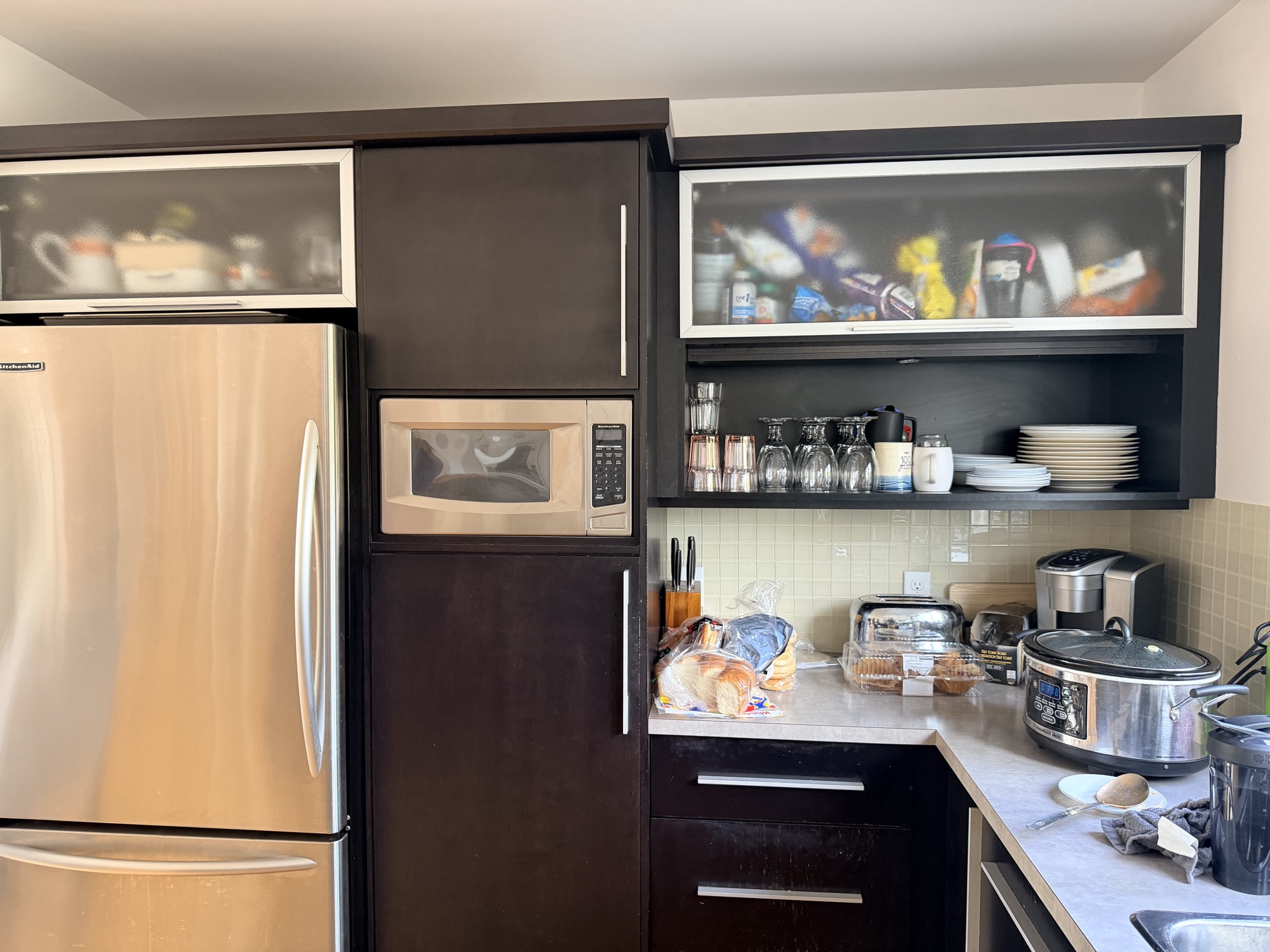Kitchen cabinet refinishing with dark modern doors.
