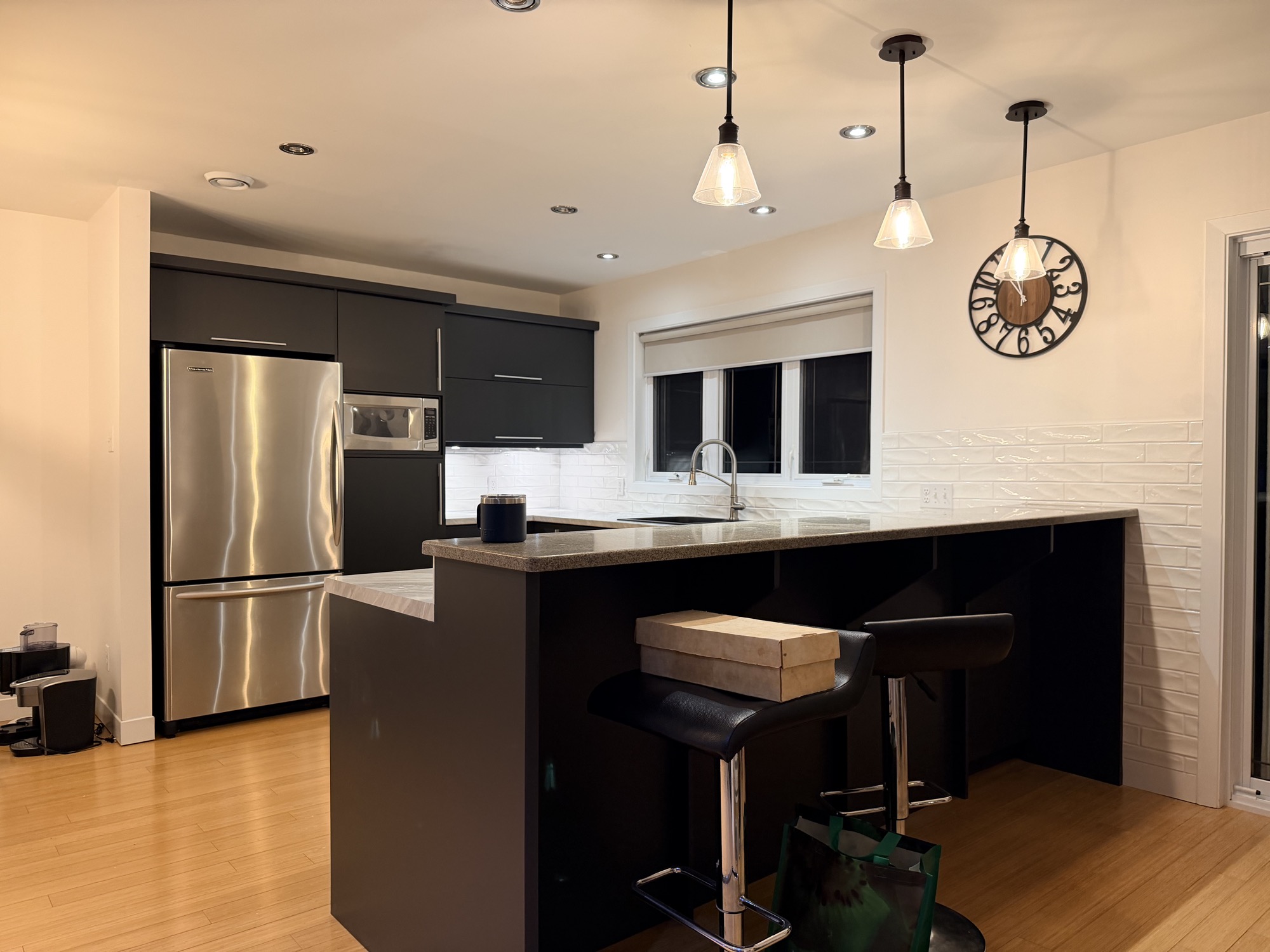 Completed kitchen cabinet refinishing with updated island & backsplash.
