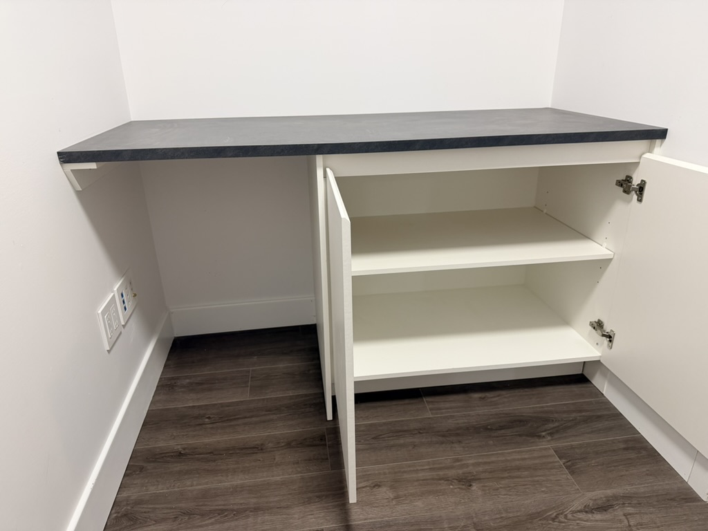 Walk-in closet with custom cabinets and shelving.